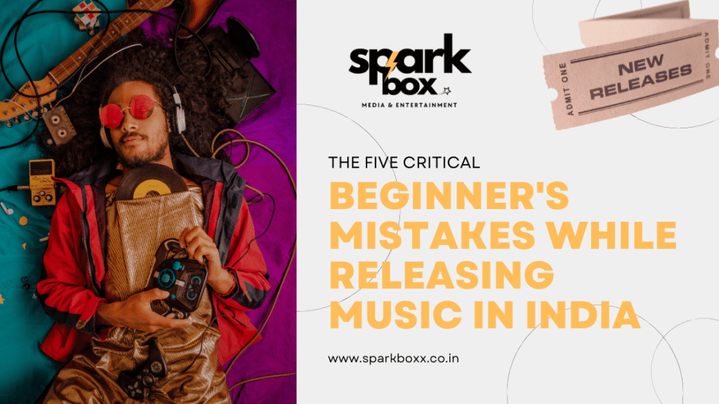 A vibrant promotional graphic featuring a relaxed musician lying on a colorful background surrounded by instruments like a guitar and recording equipment, symbolizing music creation. The text reads 'The Five Critical Beginner’s Mistakes While Releasing Music in India,' alongside Sparkbox Media & Entertainment's logo and a ticket stub labeled 'New Releases.' The website www.sparkboxx.co.in